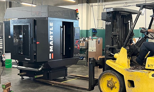 Forklift carries Mantle 3D printer into Westec Plastics shop floor