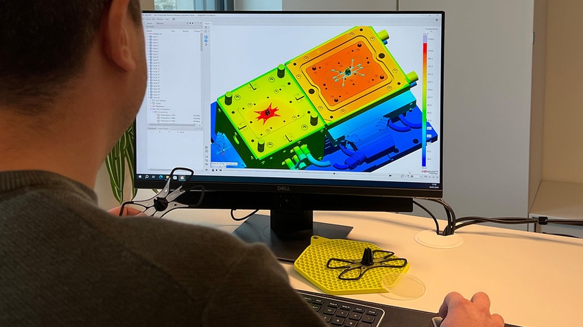 man running injection molding simulation software on computer
