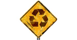 road sign showing recycling symbol