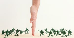 hand dividing two battalions or plastic army men