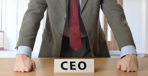 man leaning on CEO desk
