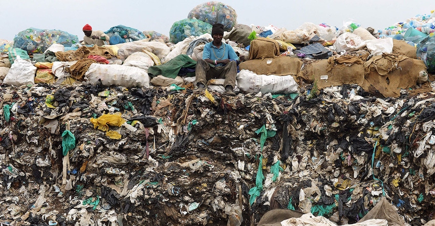 man sitting on trash dump in Kenya