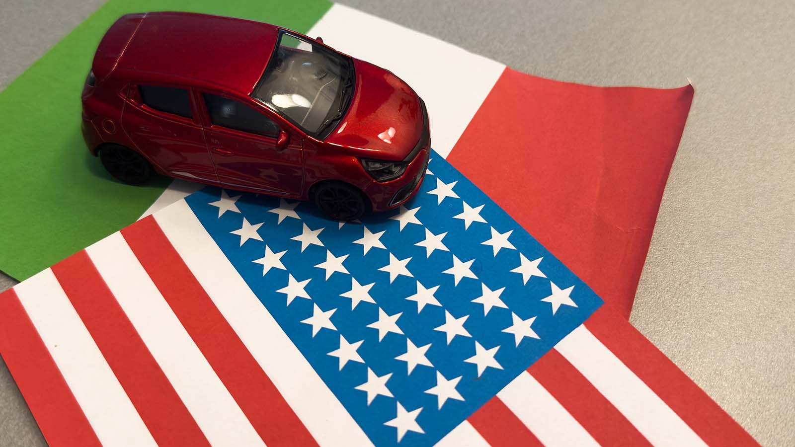 toy car sitting on US and Mexico flags