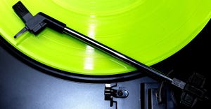 green vinyl record on turntable