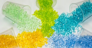 colorful plastic resins tumble from cups