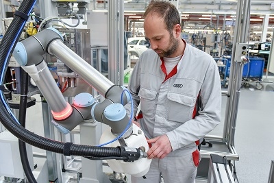 Robot works side-by-side with human colleague in installation of CFRP roof at Audi plant