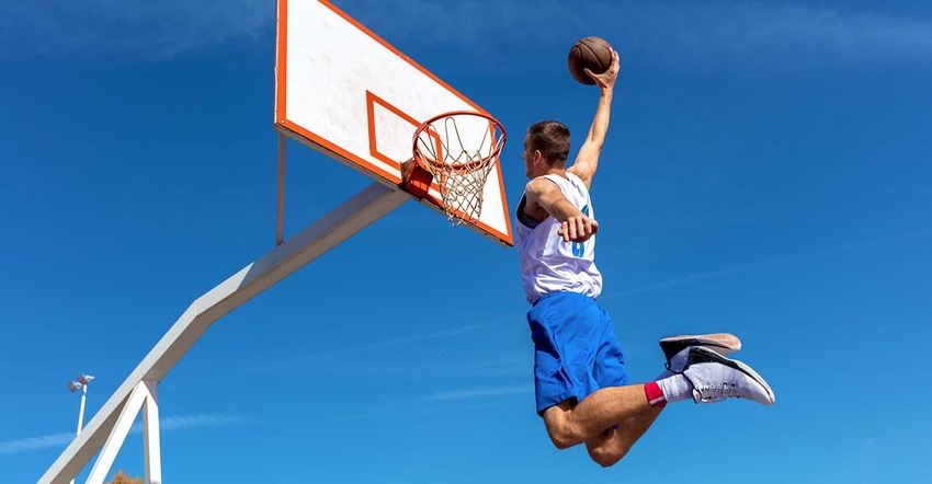 basketball player making slam dunk
