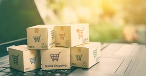 Adobe Stock photo of ecommerce boxes on copouter keyboard