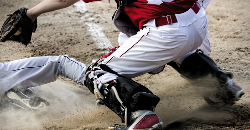 baseball player sliding into home plate