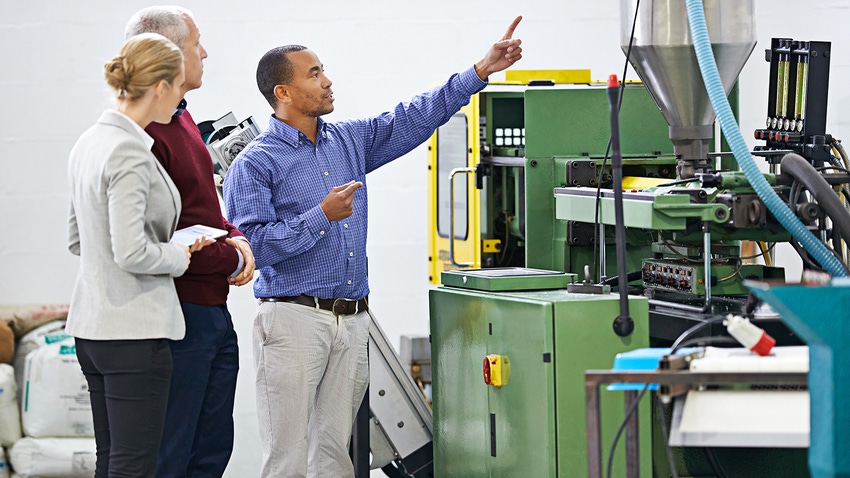 people looking at injection molding machine