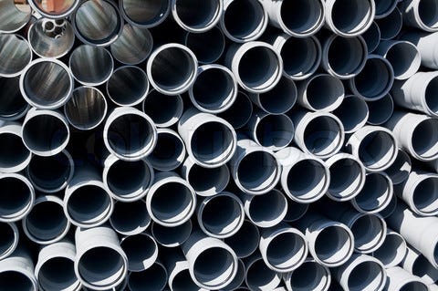 1537582-442022-gray-pvc-pipes-stacked-in-construction-site.jpg