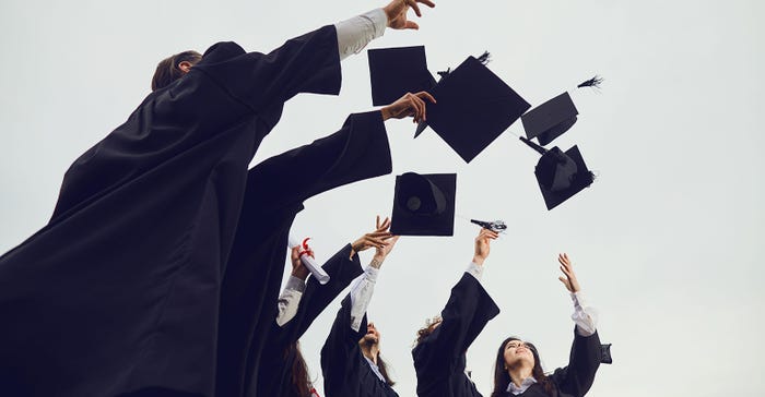 graduation caps thrown in air