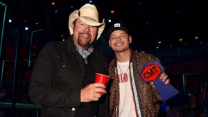 Toby Keith holding a red Solo cup