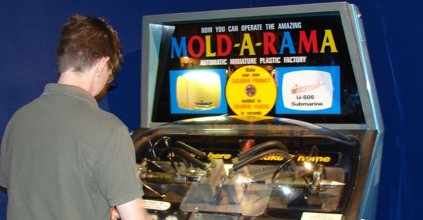 boy using Mold-A-Rama machine