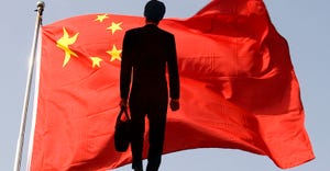businessman in front of Chinese flag