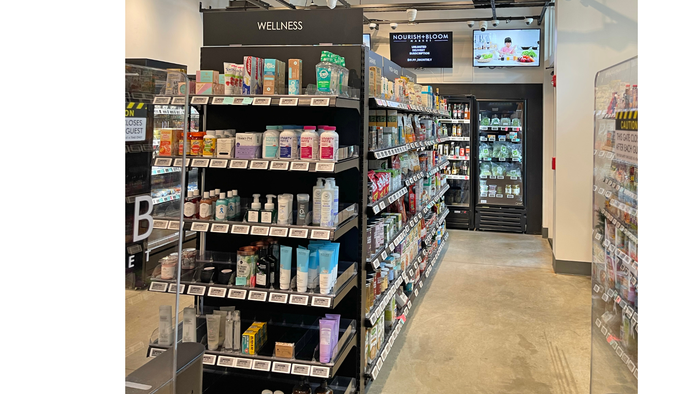 The store's wellness aisle includes dietary supplements, lotions and more. Refrigerated cases holding produce and beverages line the wall at the end of the aisle. The store's wellness aisle includes dietary supplements, lotions and more. Refrigerated cases holding produce and beverages line the wall at the end of the aisle.