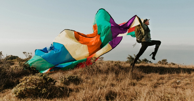 Pattie Gonia Flying a Rainbow Flag