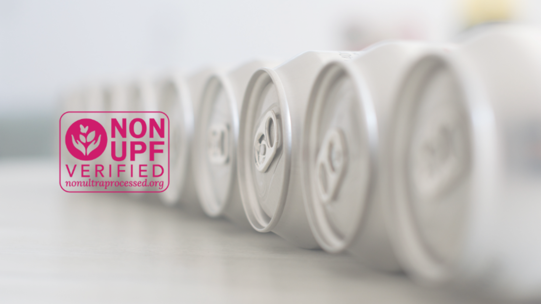 A line of cans on their side and the new Non-UPF Verified seal.