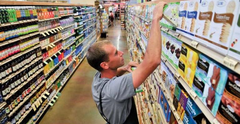 natural products store clerk stocking shelves