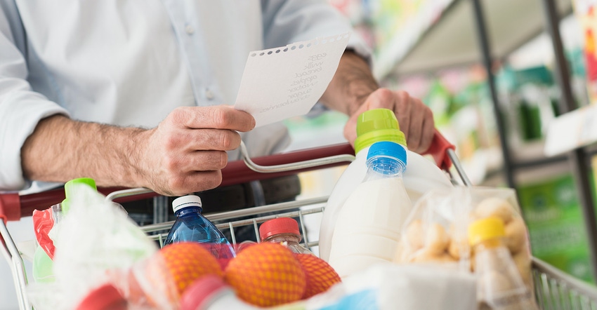 man stocking up grocery list