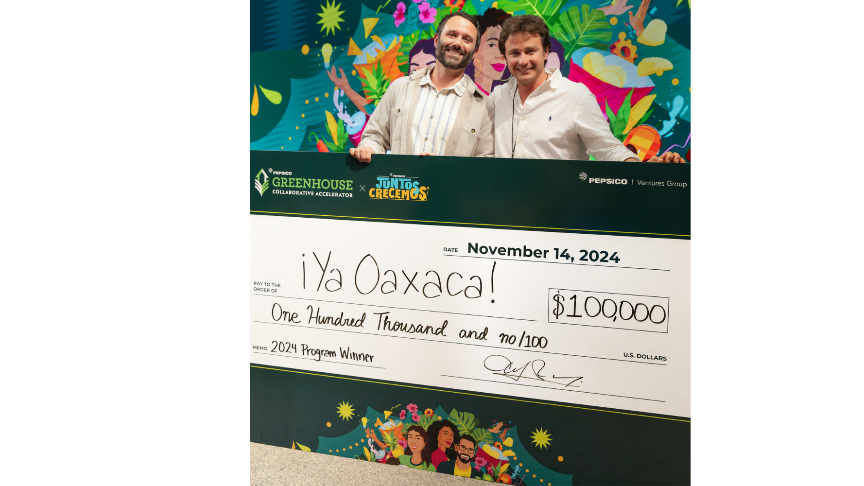 Two ¡Ya Oaxaca! executives hold a giant check for $100,000 after the brand won the prize. Two ¡Ya Oaxaca! executives hold a giant check for $100,000 after the brand won the prize.