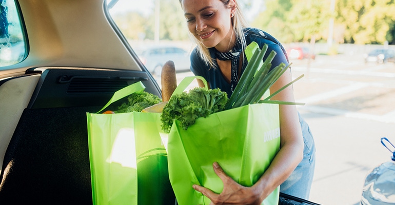 woman loading groceries into car