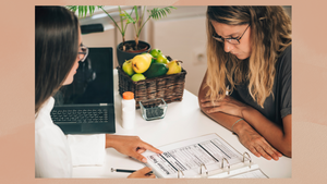 A female dietician uses an enlarged Nutrition Facts Panel to teach her female client what the numbers mean and what to watch out for.  A female dietician uses an enlarged Nutrition Facts Panel to teach her female client what the numbers mean and what to watch out for.