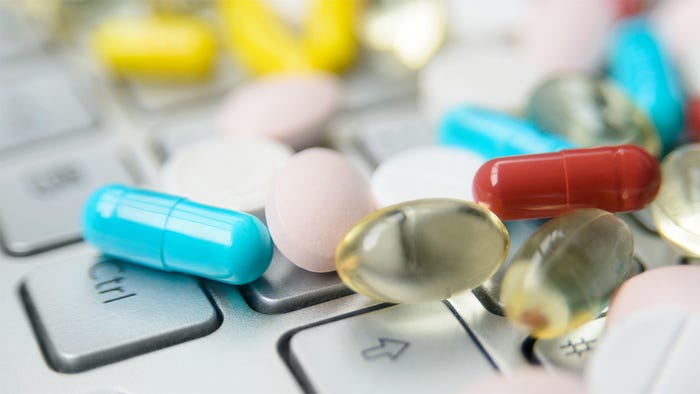 dietary supplements scattered across a laptop keyboard