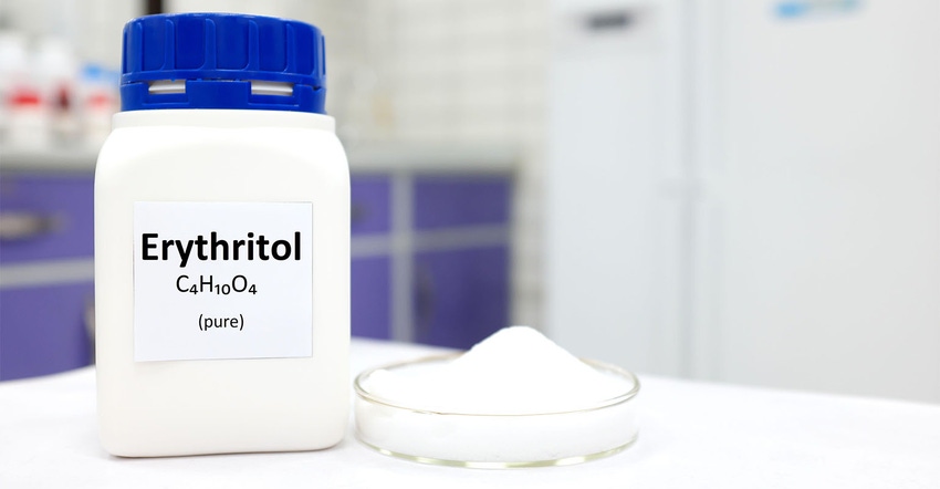 bottle of pure erythritol sugar substitute with a small pile of erythritol on a counter top