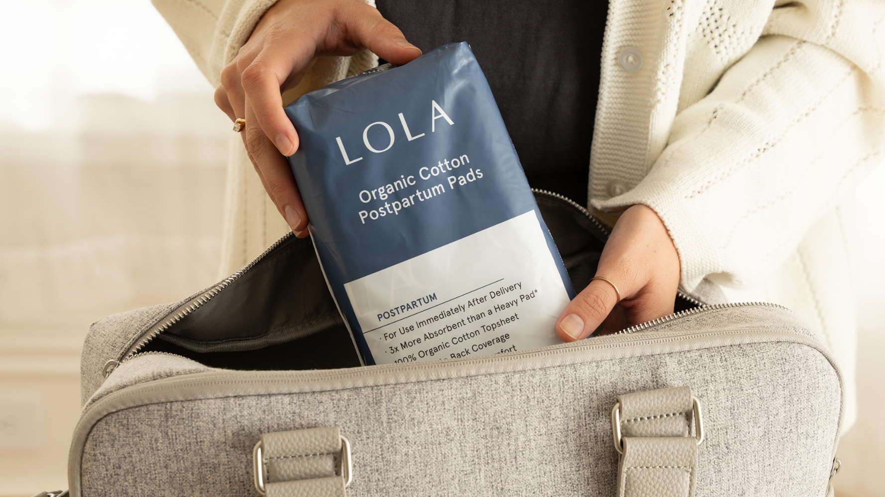 Pulling a box of LOLA tampons out of a purse