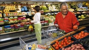 Man and woman shopping for fresh produce as part of a healthy diet. 