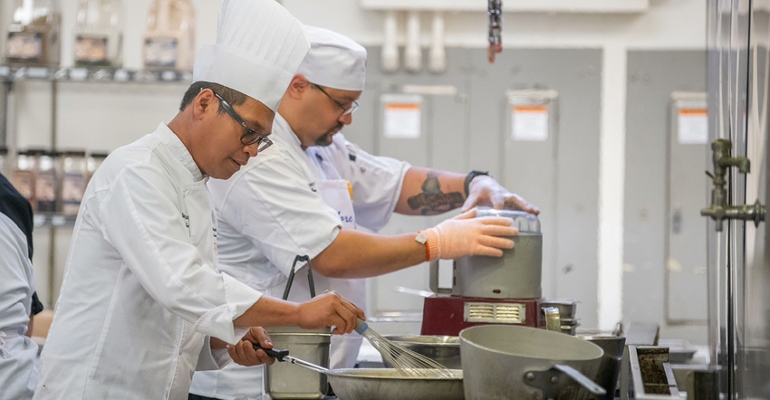Herlan Manurung, an executive chef at Rochester Institute of Technology, cooks plant-based foods during a tasting event.