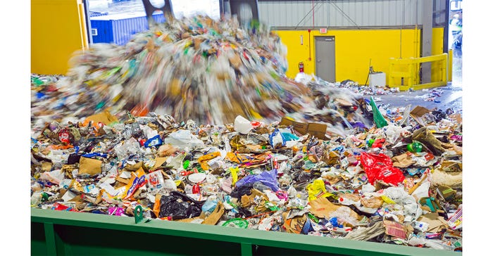 materials are dumped into a container at a recovery center | What to consider when creating sustainable packaging