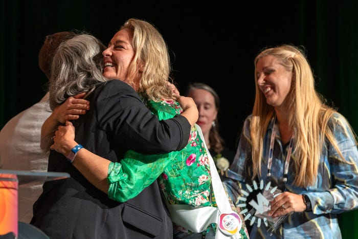 Slo Naturals co-founders Monica Budd (center) and Vanessa Farrington (right) accept their NEXTY Award at Natural Products Expo West 2024. Credit: Bryan Beasley Photography