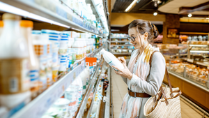 Woman reading product labels in grocery store