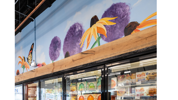 A mural that includes large images of a butterfly and various flowers adorns the wall above the frozen section's freezers. A mural that includes large images of a butterfly and various flowers adorns the wall above the frozen section's freezers.