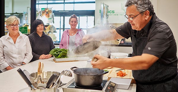 Basics Market President Fernando Divina teaches customers how to cook with local ingredients