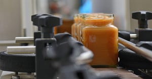 Honey is pumped into jars on a packing line | Natural Products Business School at Expo East