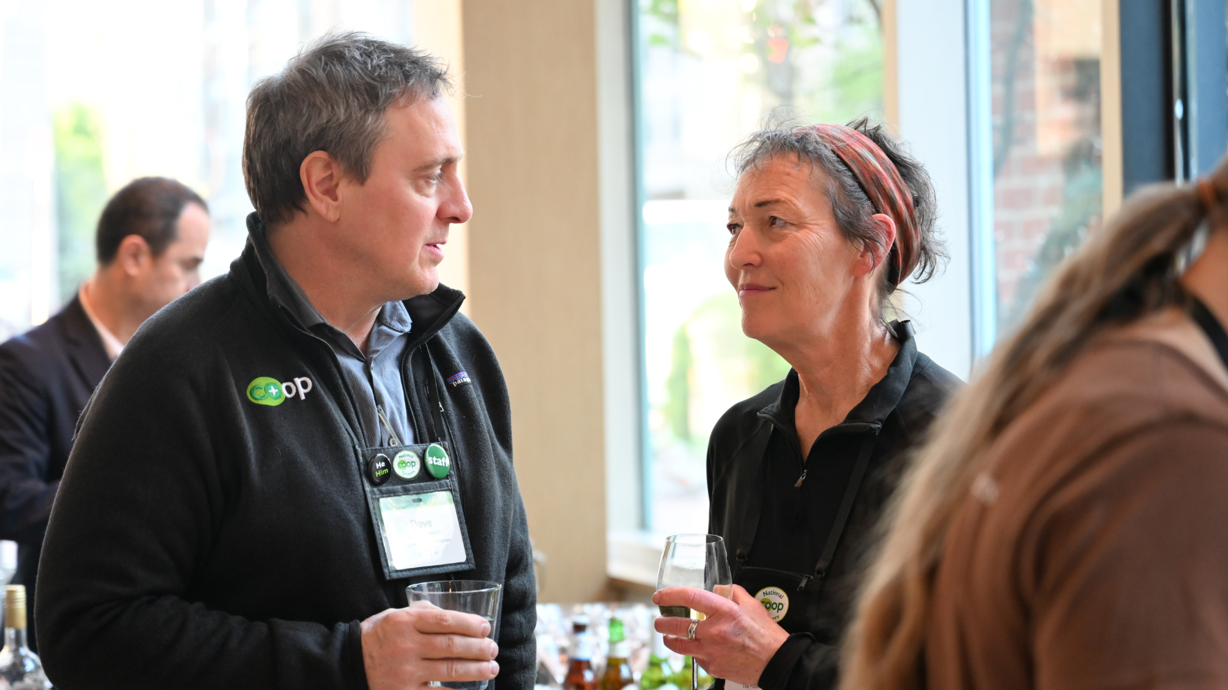 Dave Schermerhorn talks to a woman at a social function. 