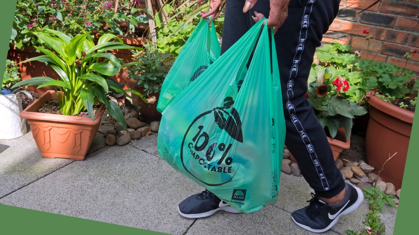 A woman carries shopping bags that are 100% compostable, according to the retailer using them.