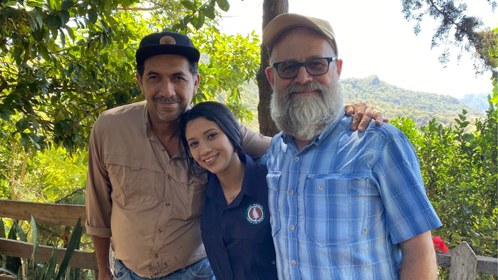 Coffee farmers Byron and Sara Corrales pose with Mickey McLeod, co-founder and CEO.