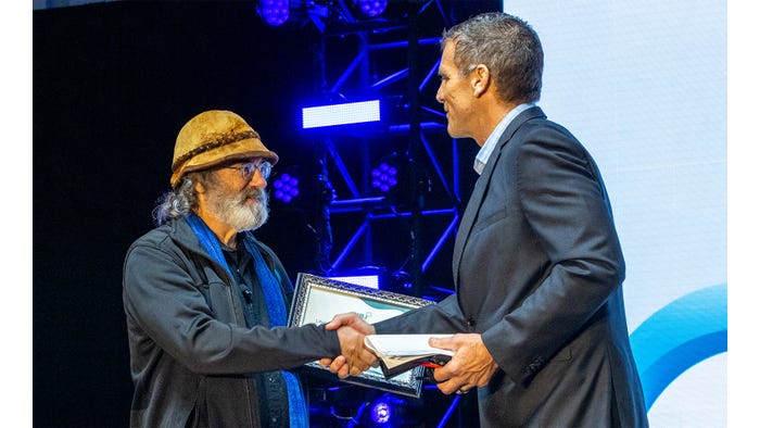 Paul Stamets, left, receives the Nutrition Business Journal Lifetime Achievement Award from Thomas Aarts, founder of NBJ. 