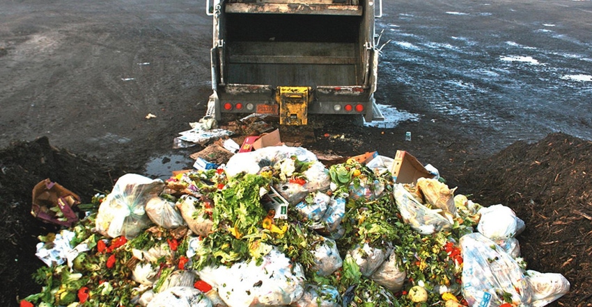 food waste behind garbage truck