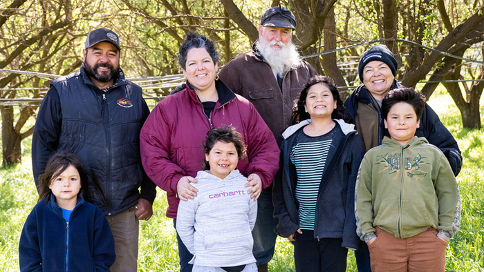 The Burroughs family continues to operate the farm and almond orchard. Back row, from left, Heriberto Montes, Benina Burroughs Montes, and Ward and Rosie Burroughs. The Montes children, in the front row, are very involved in the farm, as well.