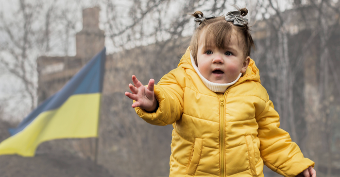 NBJ Awards Mission and Philanthropy | DoTERRA Healing Hands | Ukrainian toddler in front of army defenses