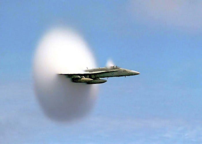 1512px-FA-18_Hornet_breaking_sound_barrier_(7_July_1999)_-_filtered_700.jpg