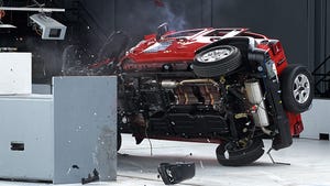The Jeep Wrangler rolls over on impact in the IIHS small overlap frontal crash test.