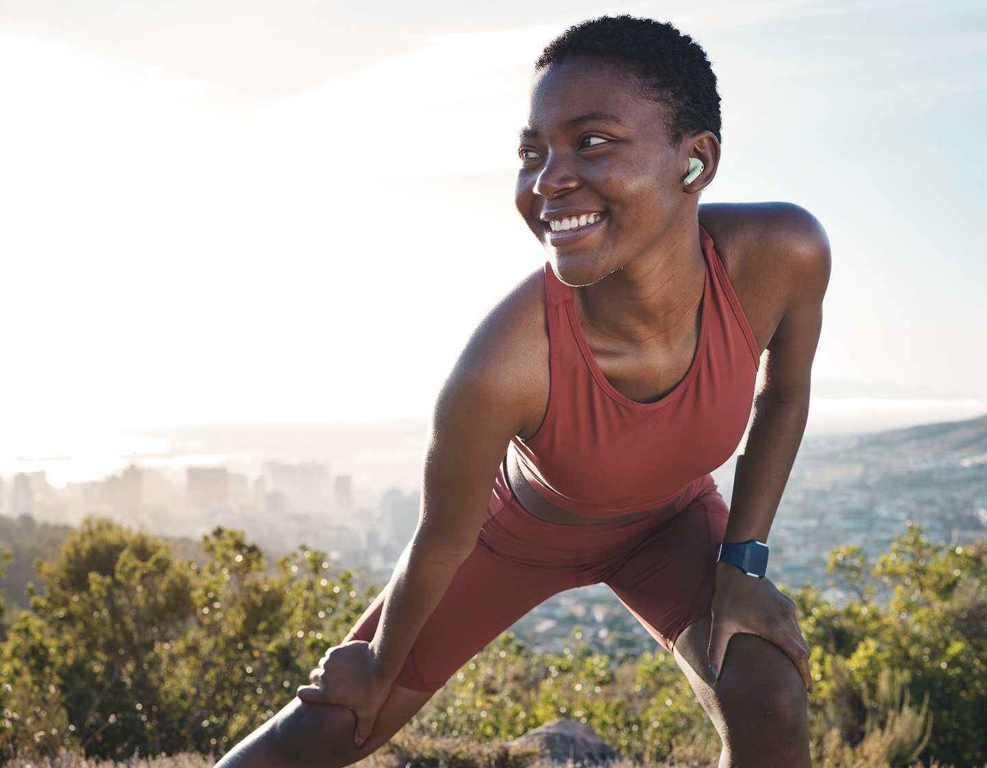 Woman smiling whilst stretching after her work out
