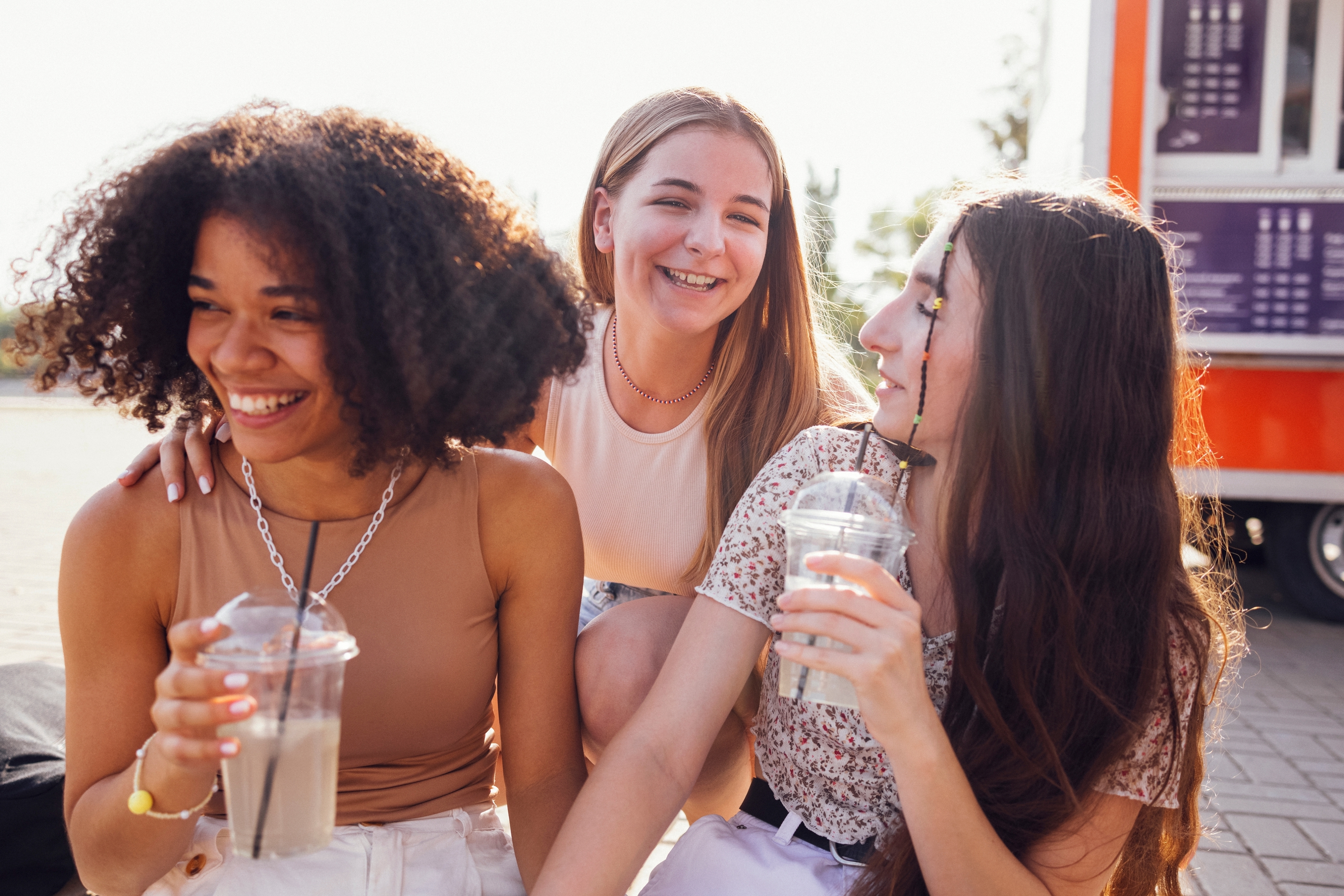 Three girls enjoying a drink together