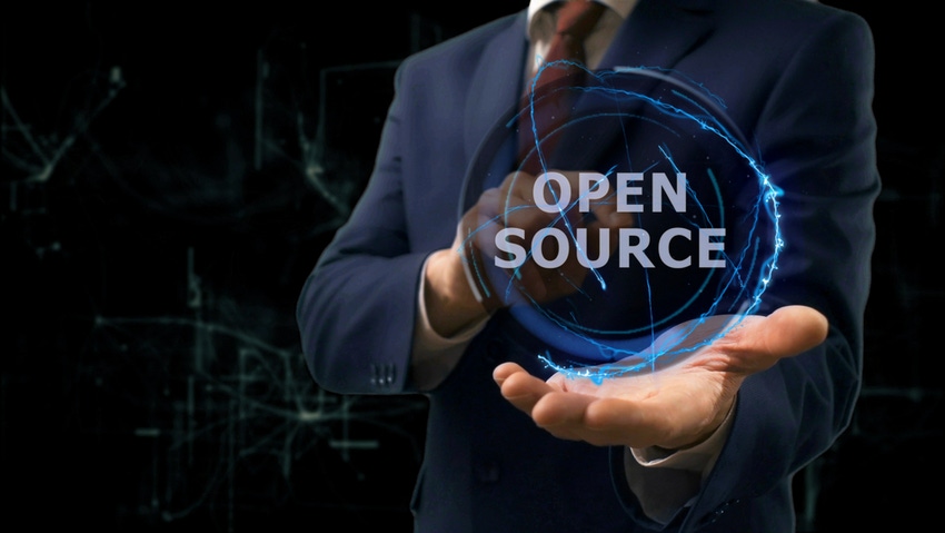 Man holds orb with "open source" in it
